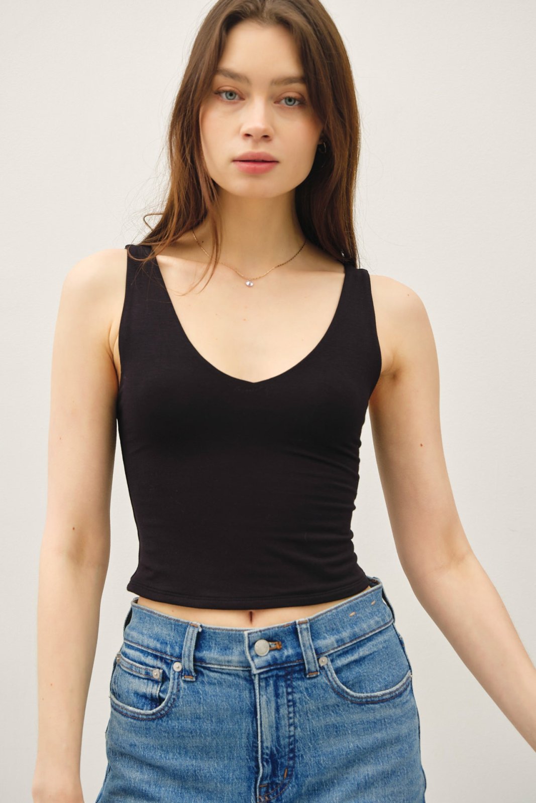Black double-lined crop tank top, perfect for summer, from a coastal boutique, ideal for stylish women's fashion.