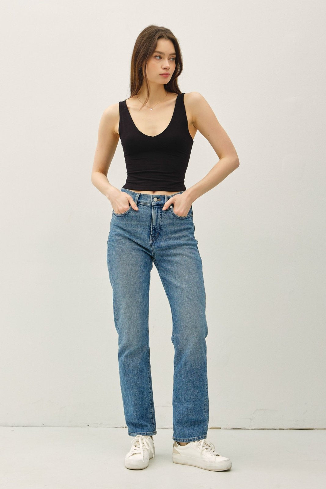 Black double-lined crop tank top styled with high-waisted jeans, perfect for coastal boutique clothing and summer outfits.