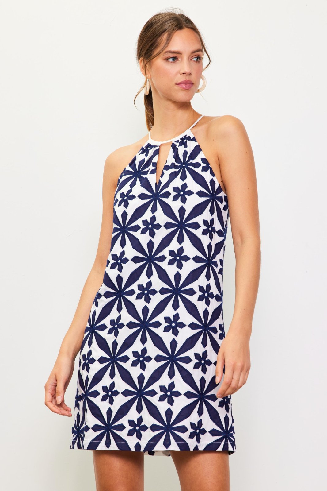 Hope Dress from a coastal boutique featuring an embroidered halter design, perfect for tropical vacations. Sizes available.