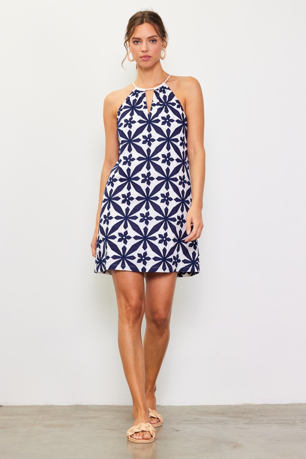 Hope Dress from a coastal boutique, perfect for beach outings. Halter style with floral pattern, ideal for tropical vacations.