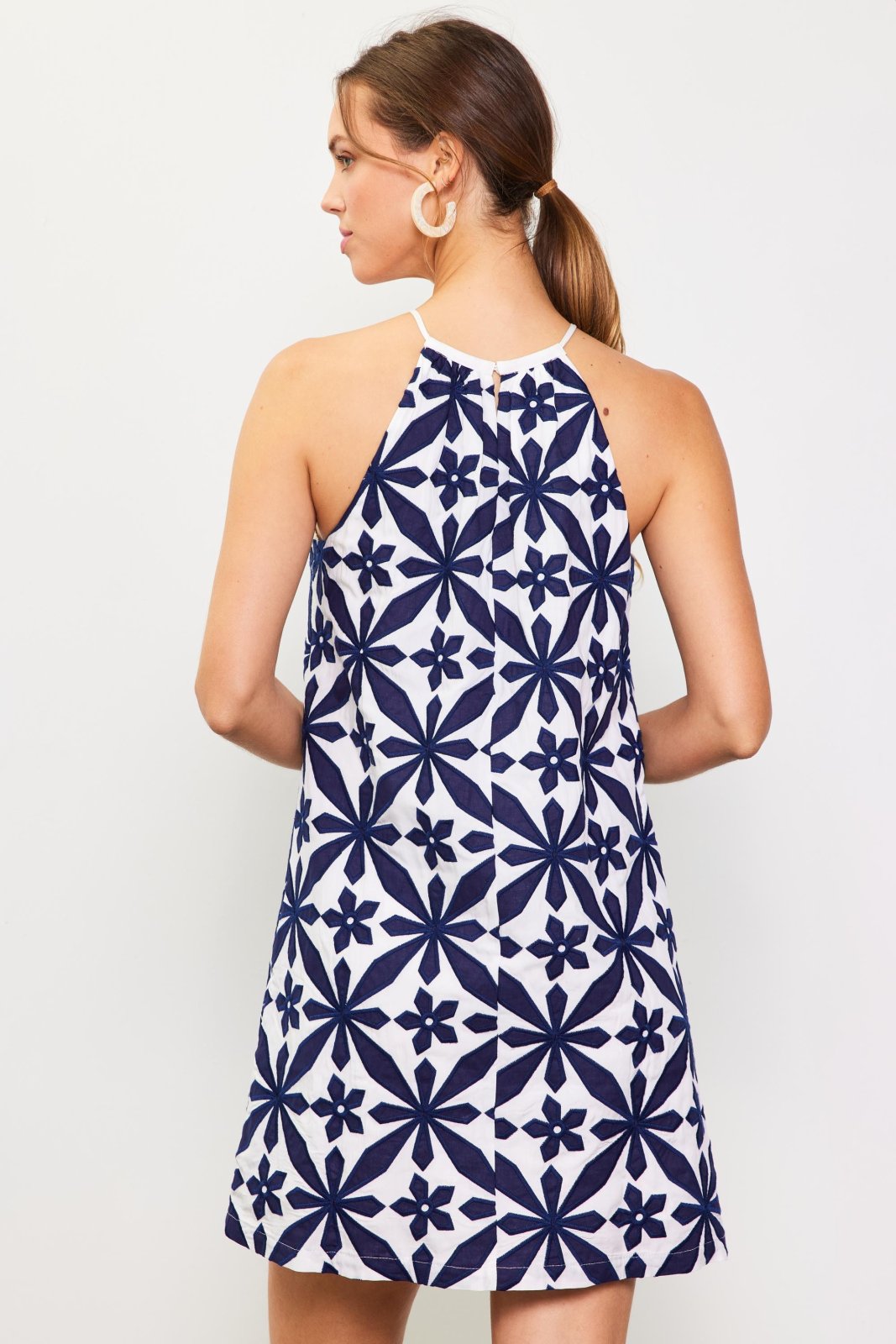 Navy embroidered halter dress from coastal boutique clothing, perfect for tropical vacations and stylish women's fashion.
