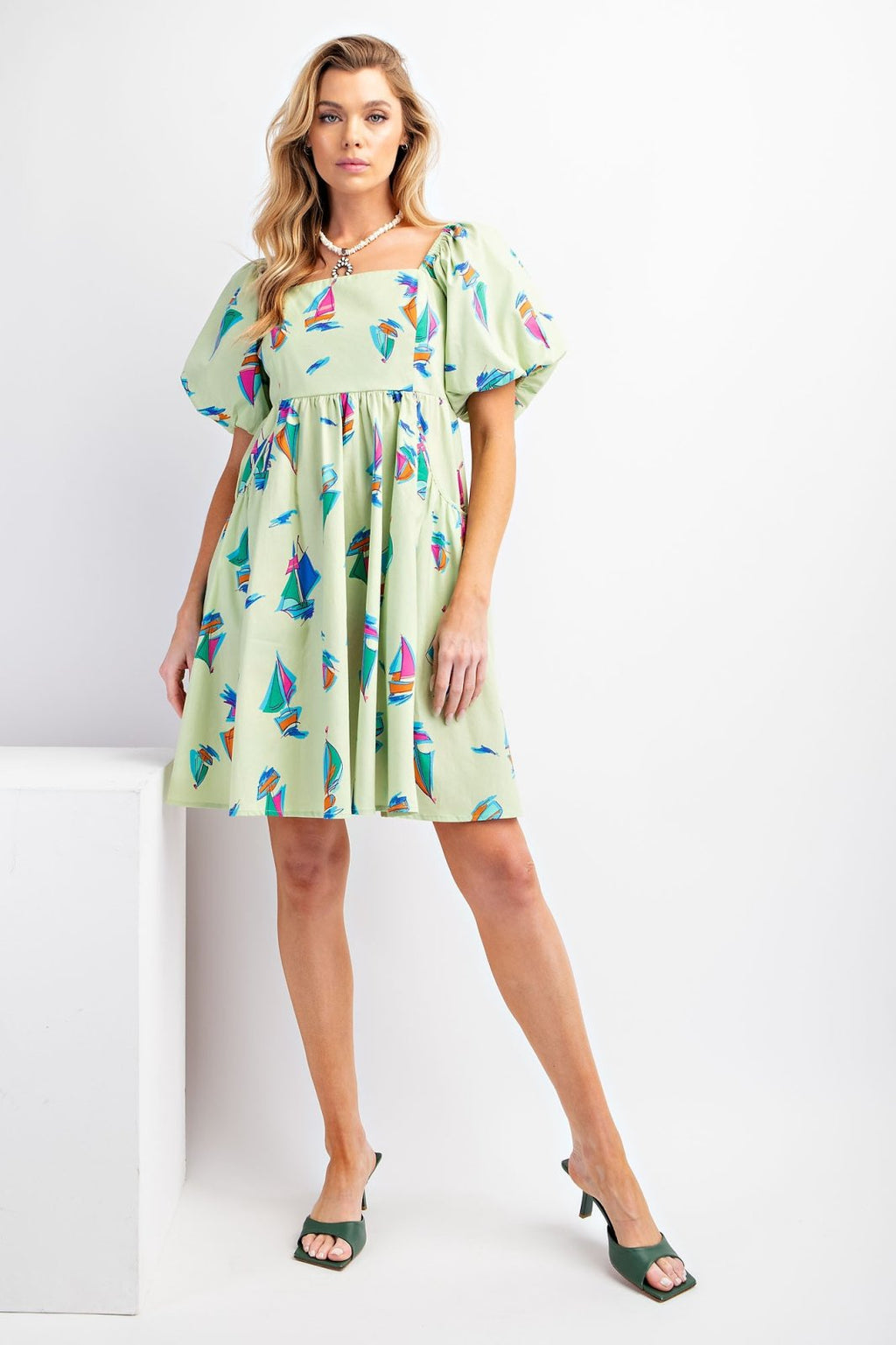 Cali Dress from our Port Aransas boutique, perfect beach dress for tropical vacations, featuring a playful sailboat print.