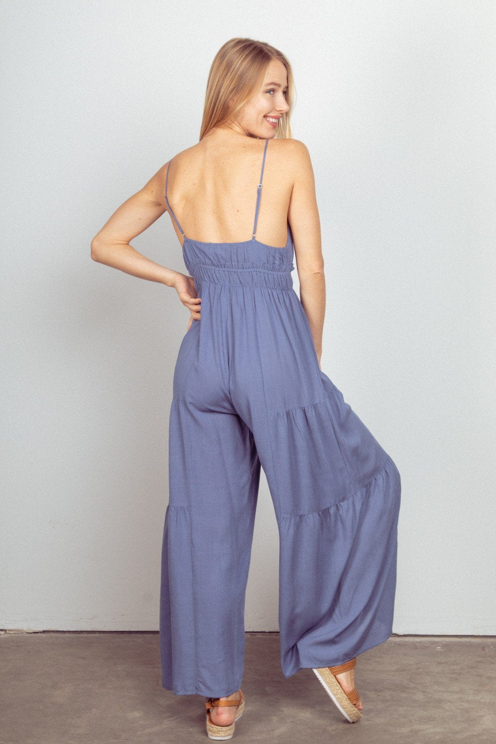 Woman wearing a DENIM BLUE JUMPSUIT from Raggdoll Boutique, showcasing trendy coastal style, ideal for summer outfits Texas.