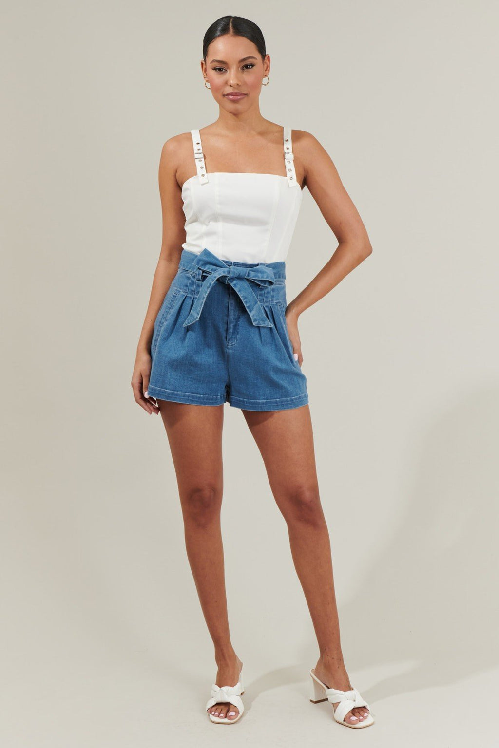 Haille Bustier Top paired with denim shorts, showcased for coastal fashion at Raggdoll Boutique in Port Aransas.