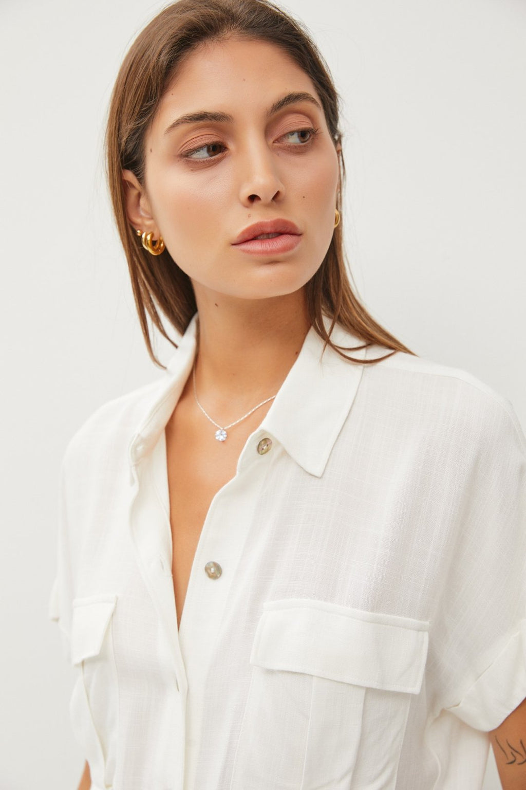 Off-White Linen Tie Front Top worn by a model, showcasing trendy coastal style at Raggdoll Boutique.