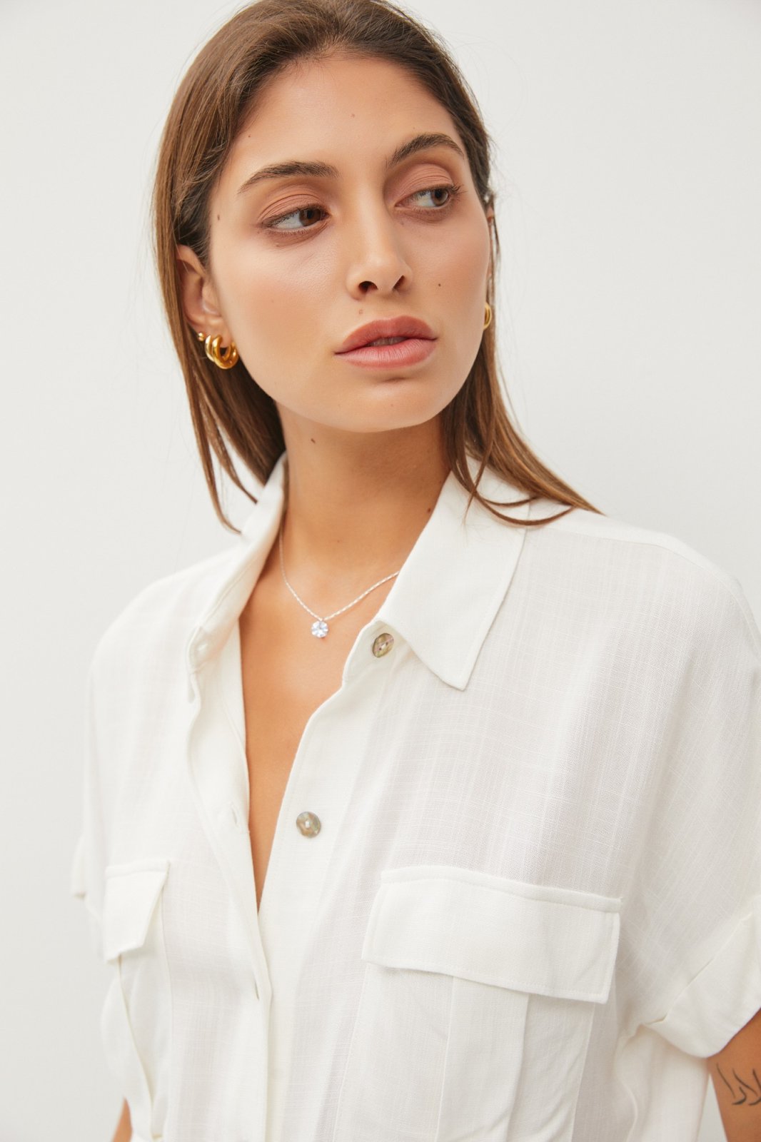 Off-White Linen Tie Front Top worn by a model, showcasing trendy coastal style at Raggdoll Boutique.