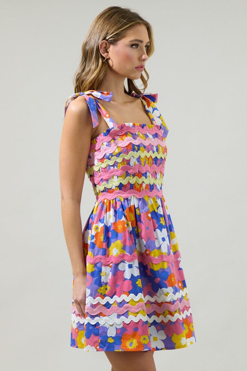 Happy Days Dress in vibrant floral print with self-tie straps and smocked panel, from Raggdoll Boutique.