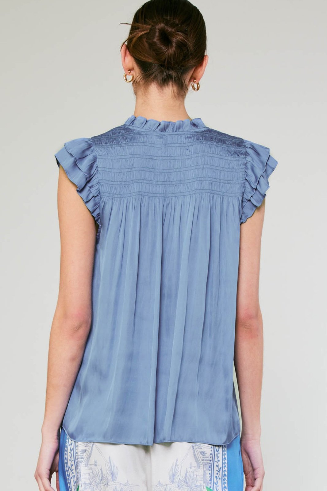Back view of the Celine Top in blue, a stylish women's top from a Port Aransas boutique, perfect for coastal vacations.
