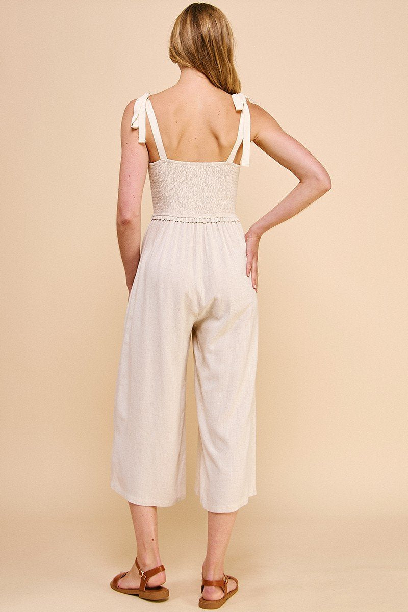 Back view of a woman in a soft linen jumpsuit from Raggdoll Boutique, perfect for summer outfits Texas.