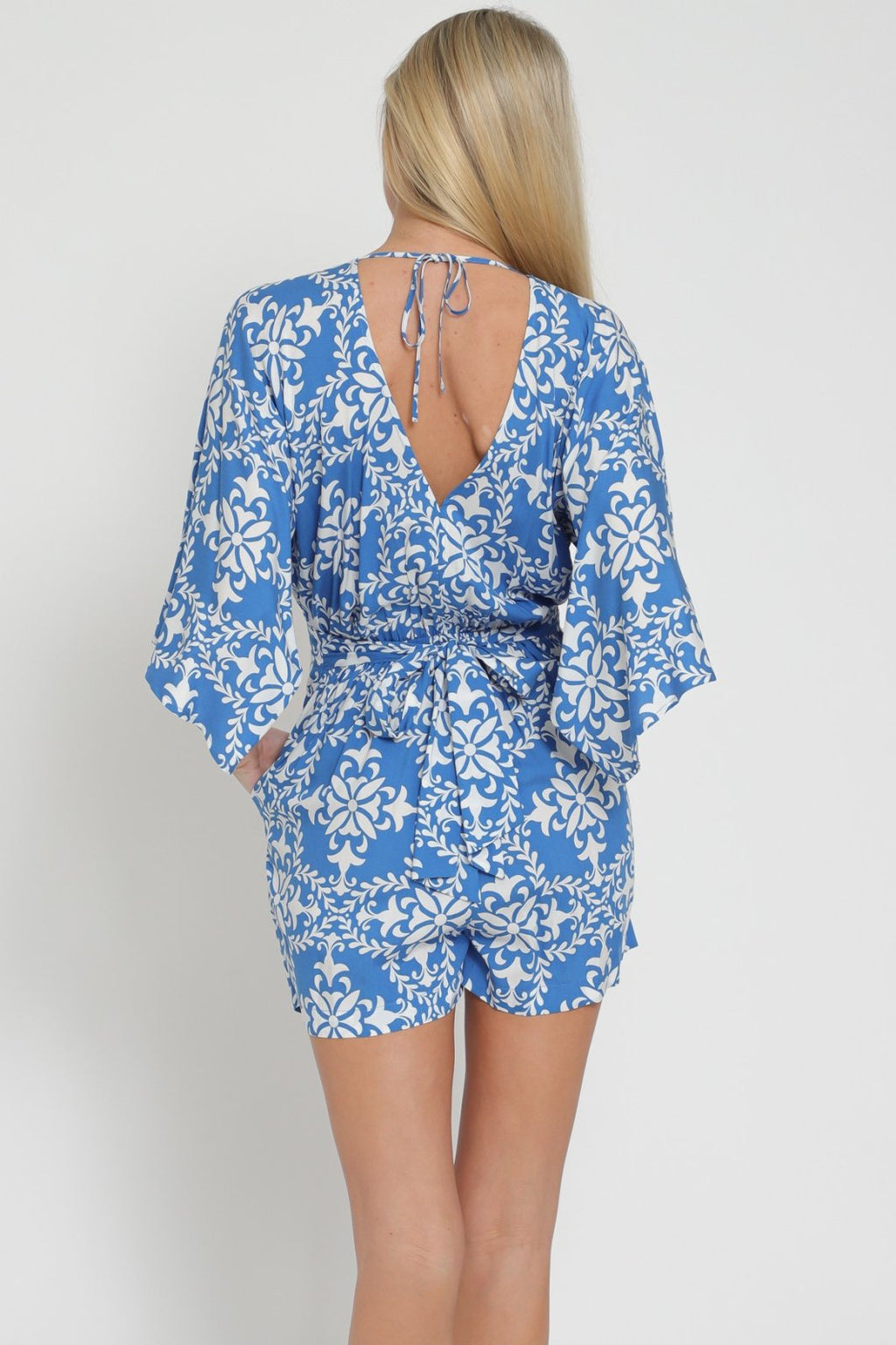 Blue and White Romper with back Detail showcasing trendy coastal style from Raggdoll Boutique.