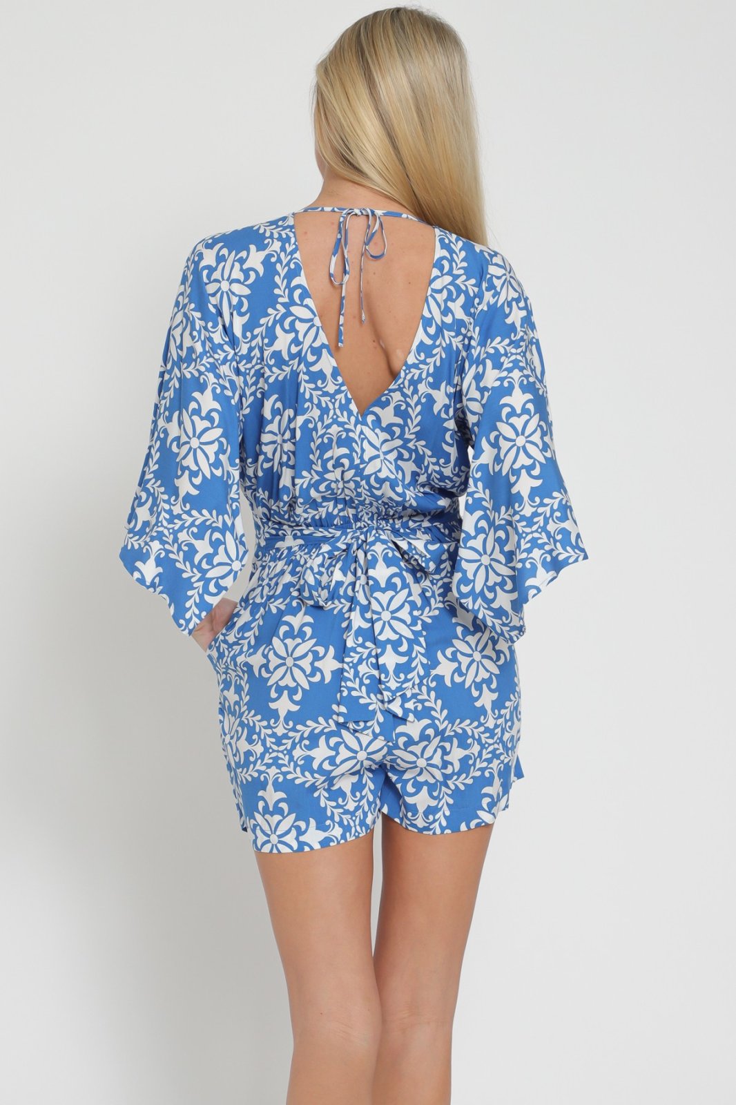 Blue and White Romper with back Detail showcasing trendy coastal style from Raggdoll Boutique.