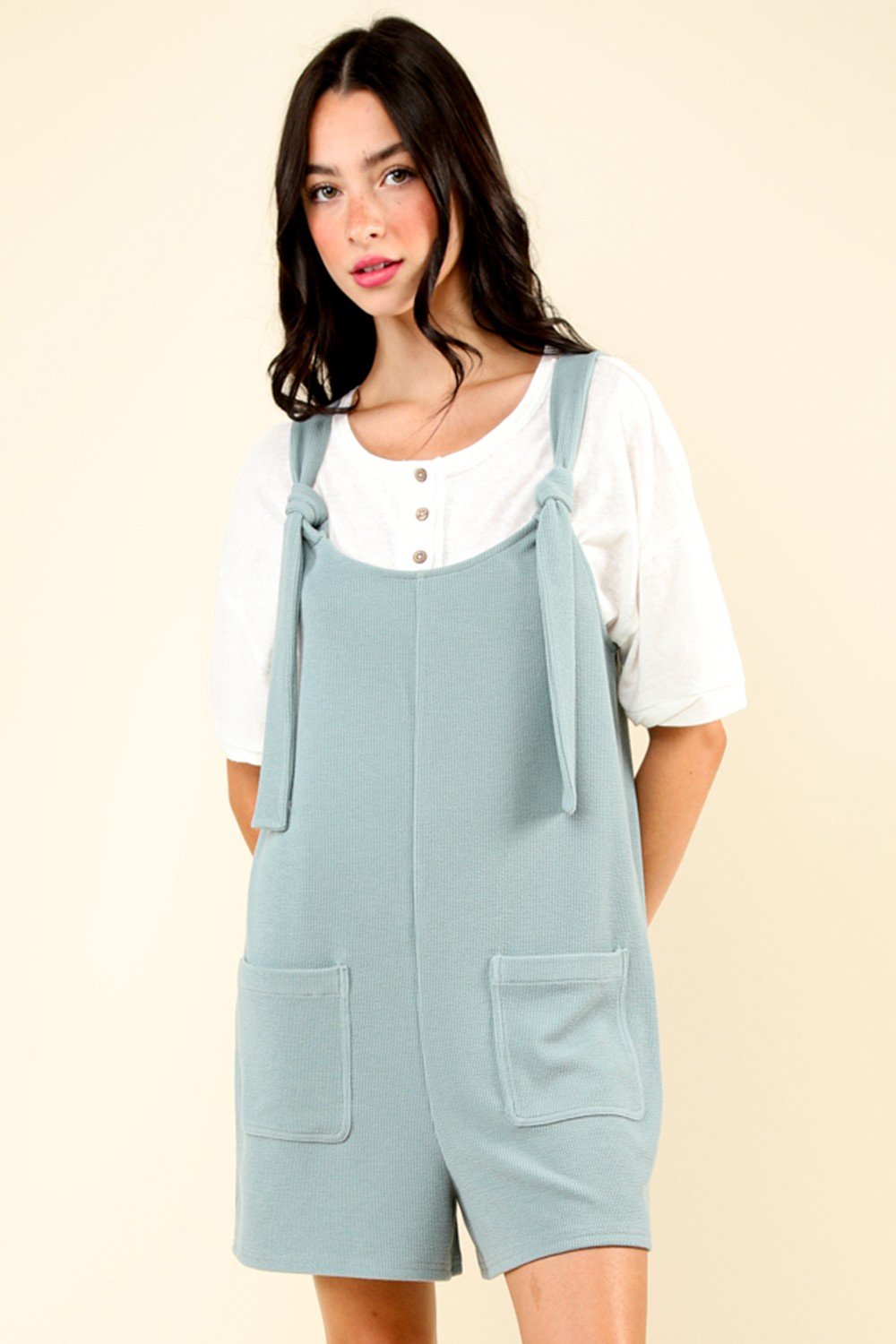 Stylish sage RILEY ROMPER with shoulder ties and front pockets, perfect for beach outings. Discover coastal boutique clothing.