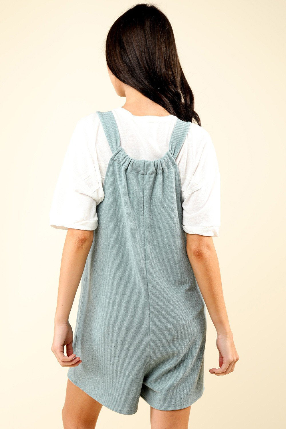 Back view of the RILEY ROMPER in sage, a stylish choice for beach dresses at coastal boutique clothing.
