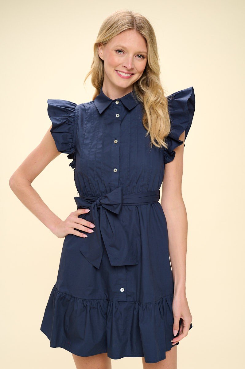 Louisa Dress featuring ruffled sleeves and tie waist, perfect for coastal boutique clothing and beach outings.