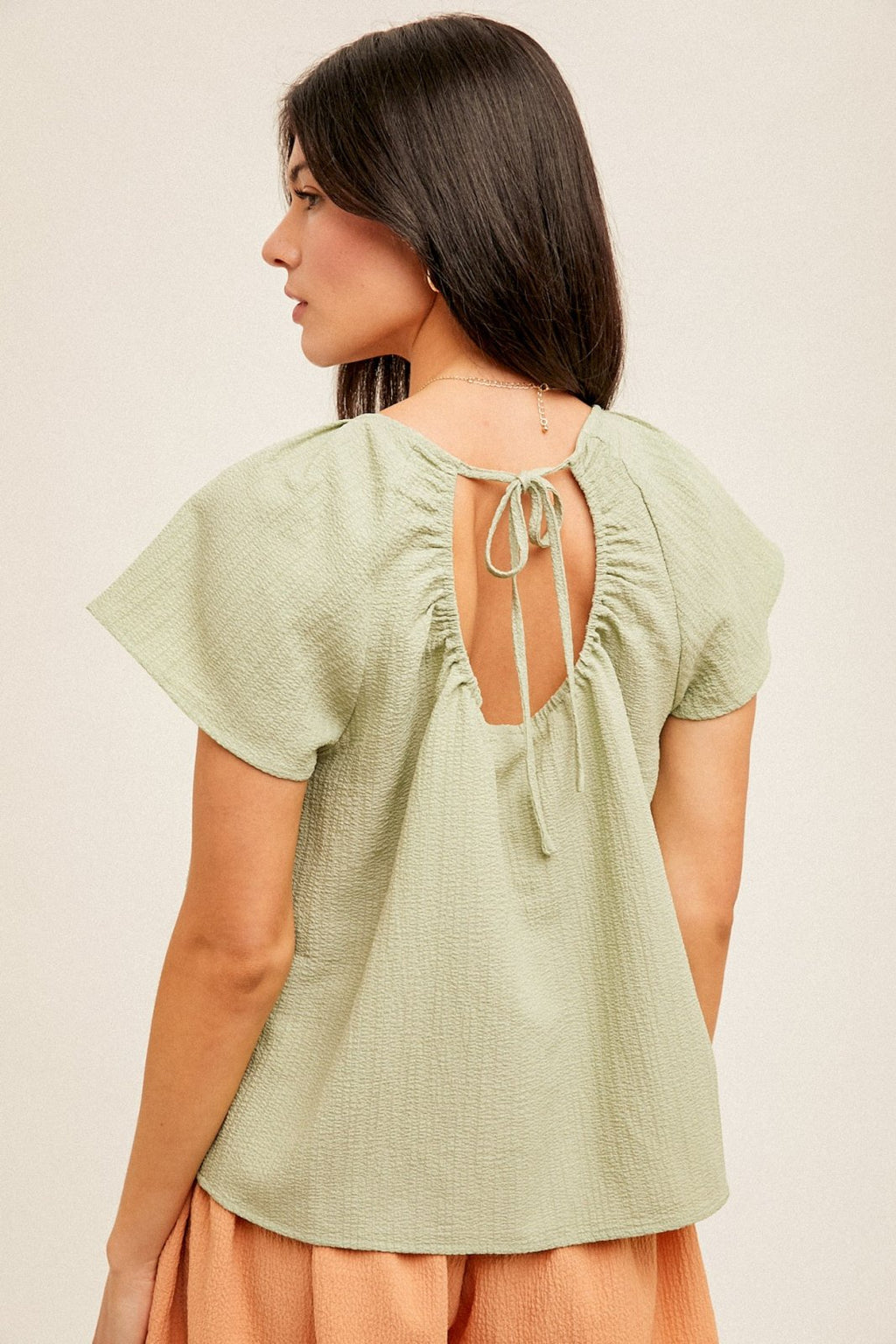 Sage Top featuring stylish back tie detail, perfect for summer outfits Texas. Available at Raggdoll Boutique.