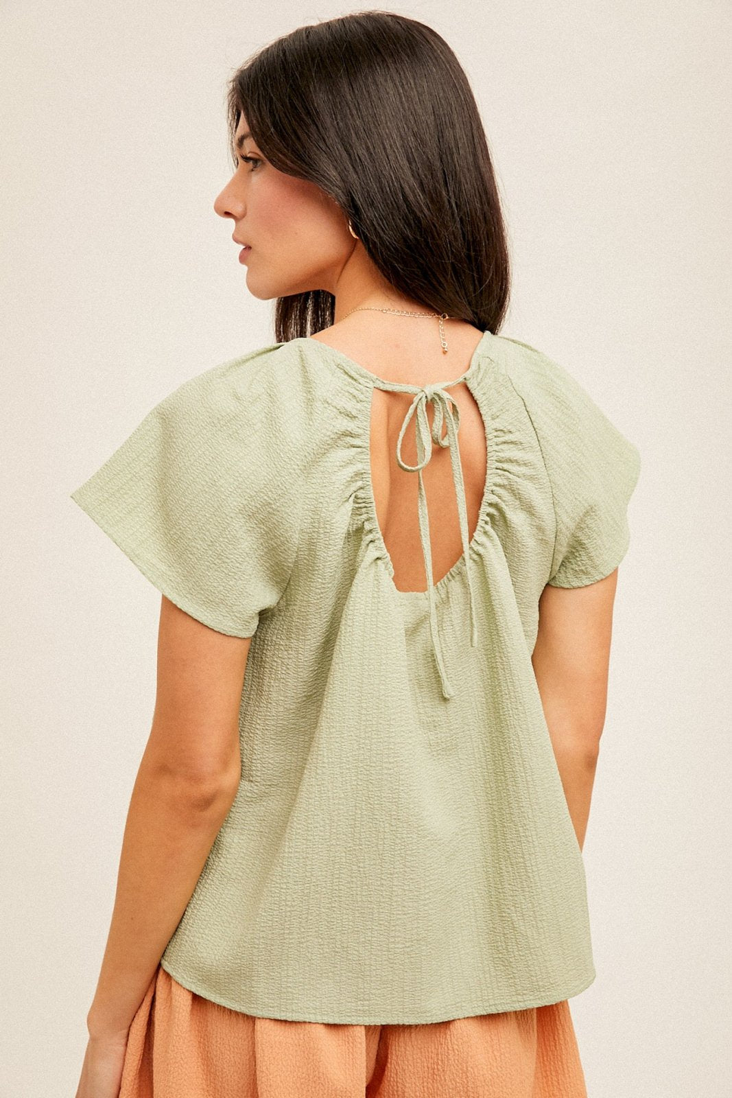 Sage Top featuring stylish back tie detail, perfect for summer outfits Texas. Available at Raggdoll Boutique.