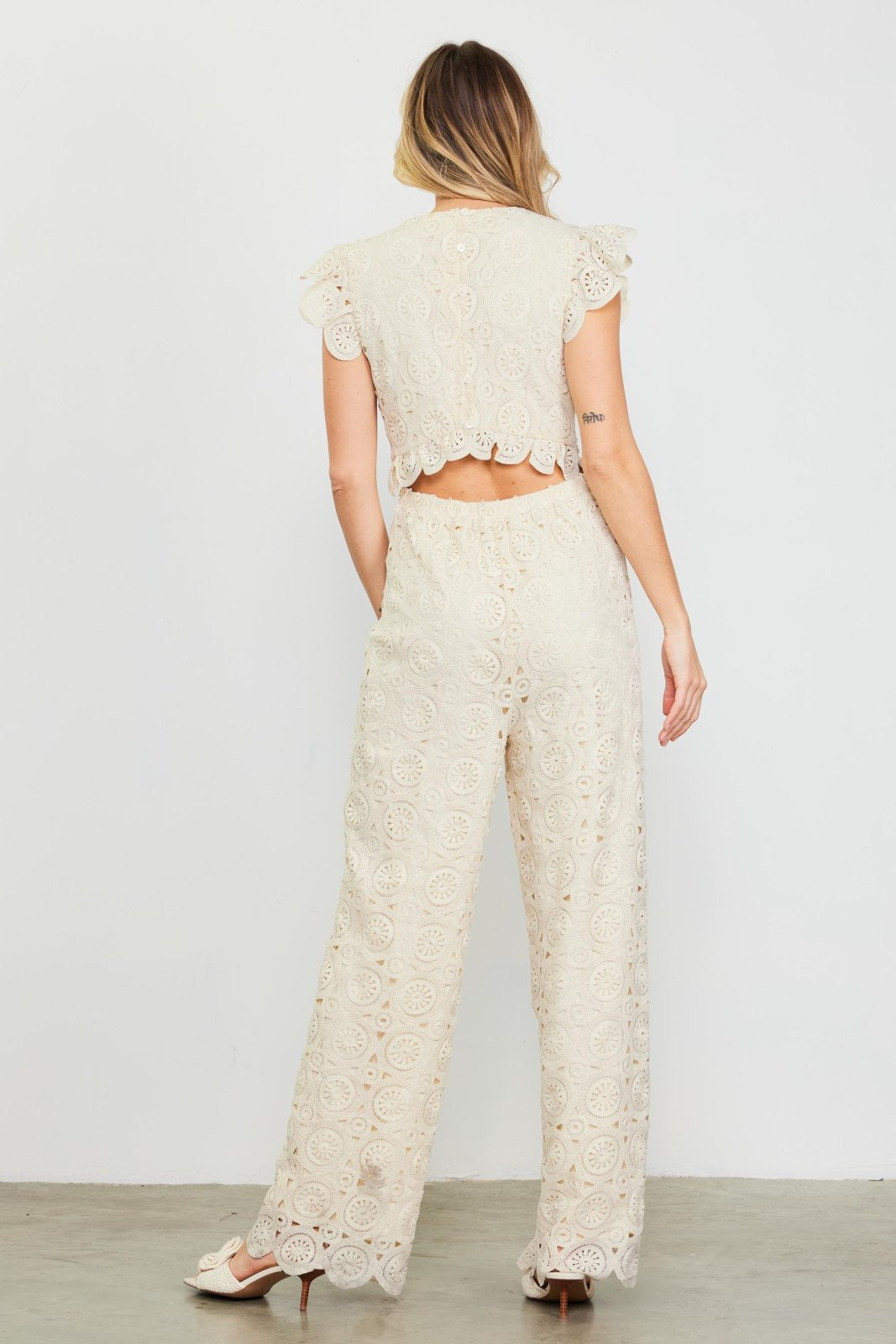 Ivory crochet jumpsuit back view, ideal for coastal boutique clothing, beach dresses, and tropical vacation outfits.