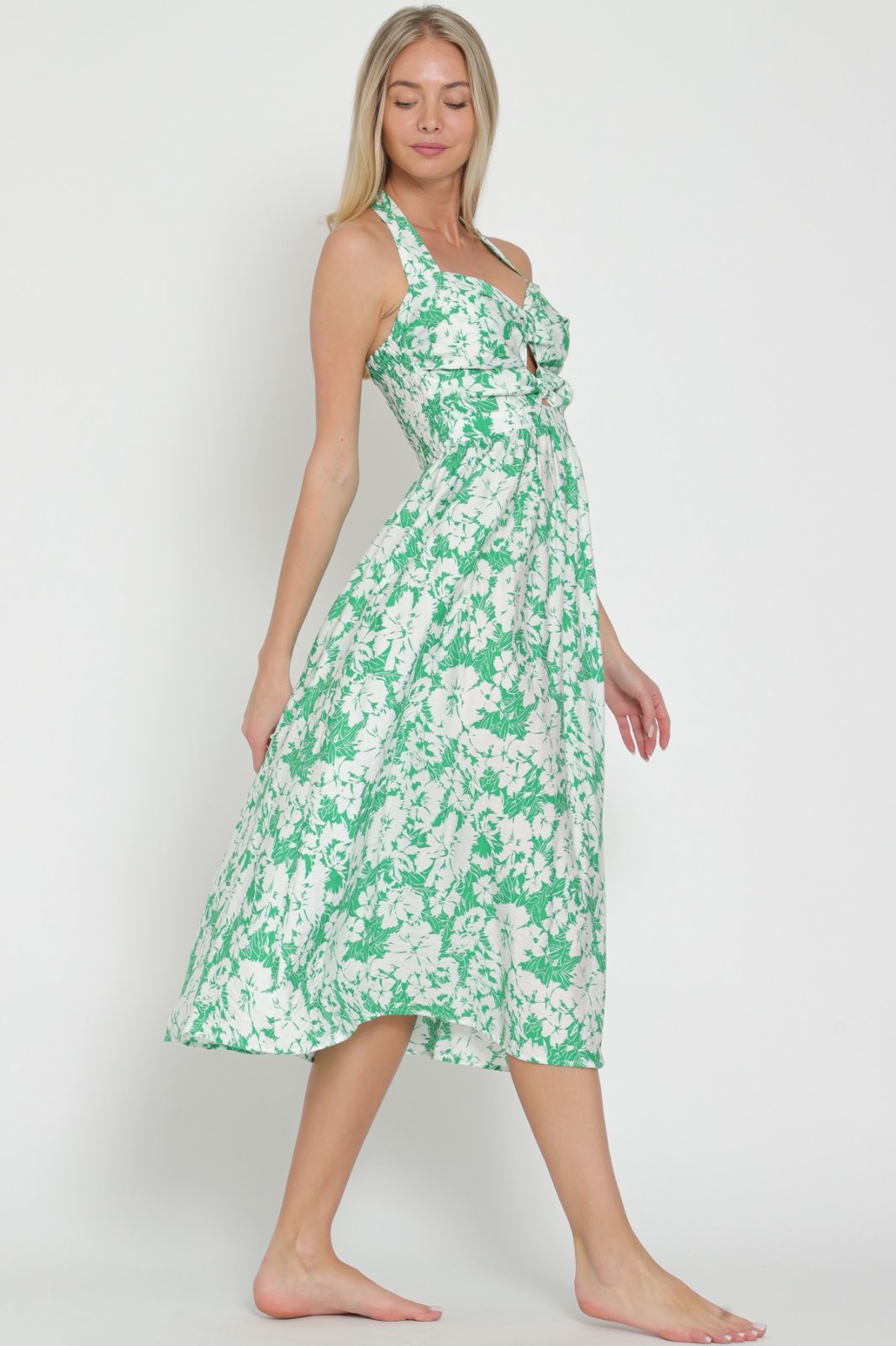 Debbie Dress worn by model, featuring floral print, available at Raggdoll Boutique, perfect for coastal fashion and summer outfits.