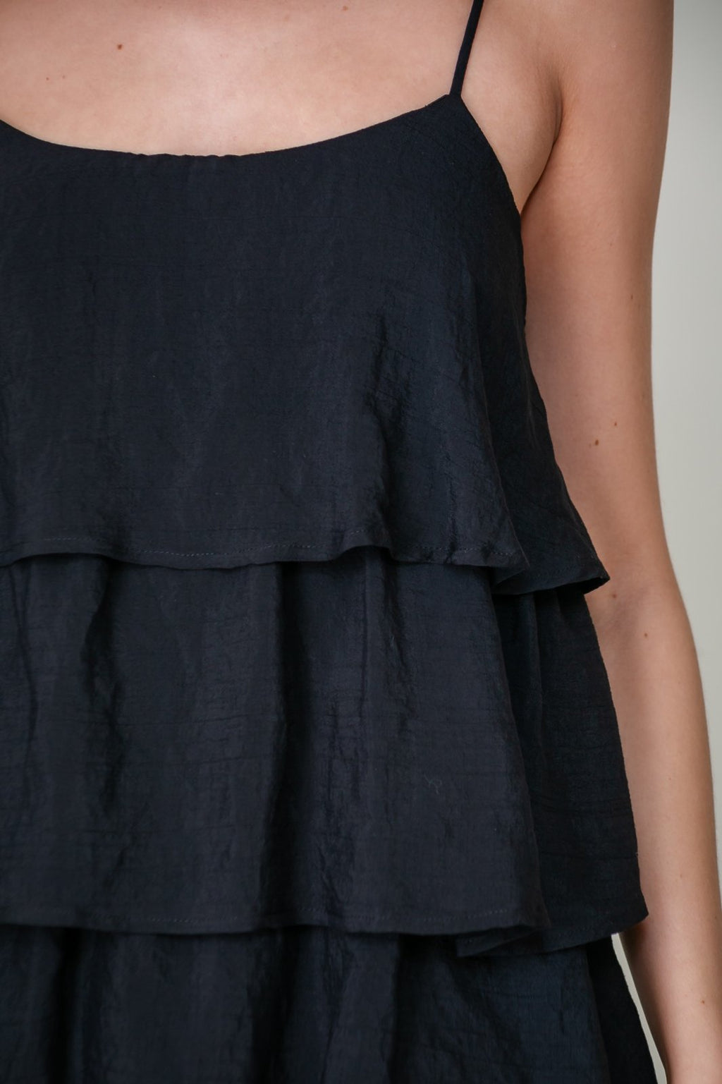 Lulu Dress sleeveless round neck mini dress from Raggdoll Boutique showcasing tiered silhouette.