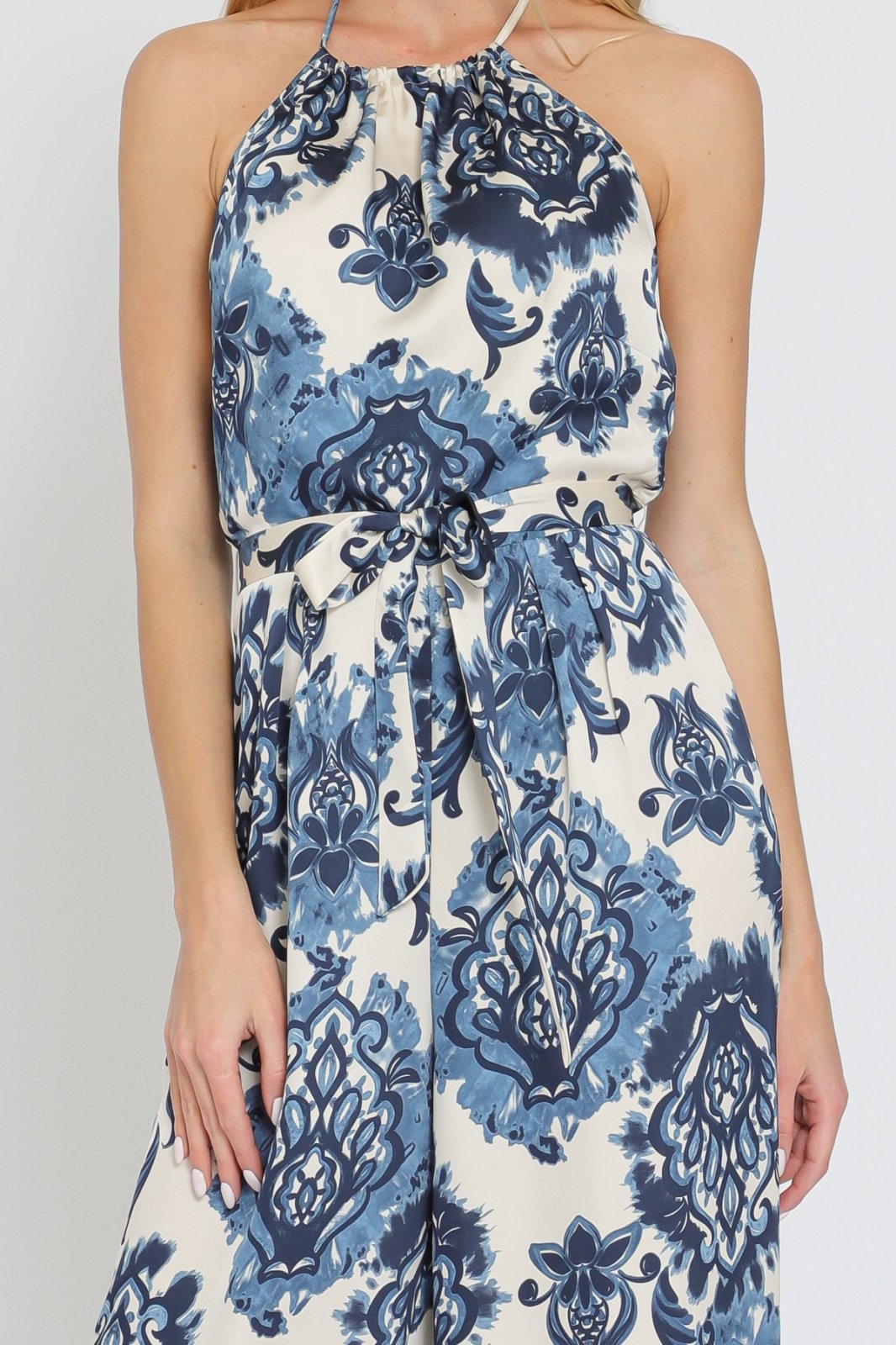 Lorna Jumpsuit in blue floral print, perfect for vacation wardrobe boutique from Raggdoll Boutique.