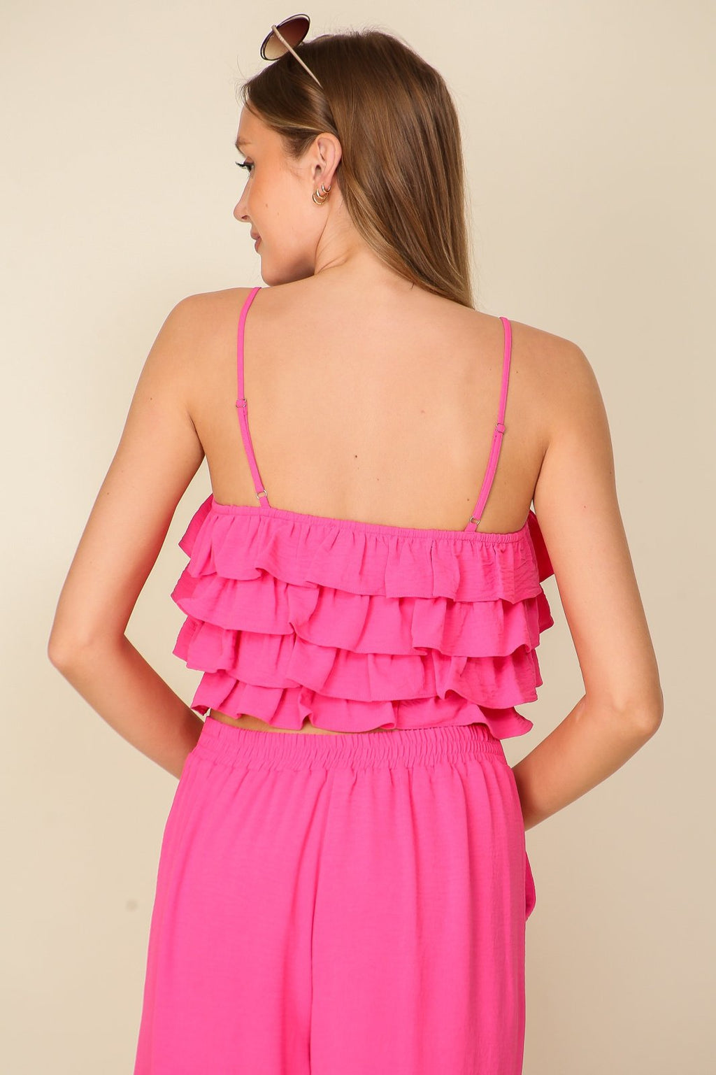 Bridgette 2Piece Set showcasing the ruffle-tiered detail and adjustable straps in vibrant pink, perfect for coastal fashion.