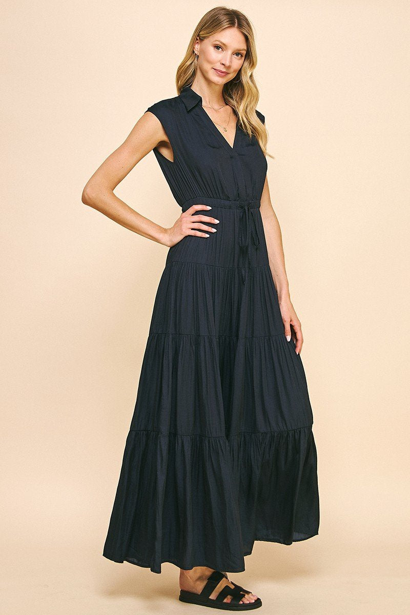 Stylish navy maxi dress with collar and tiered design, ideal for coastal boutique clothing and tropical vacations.