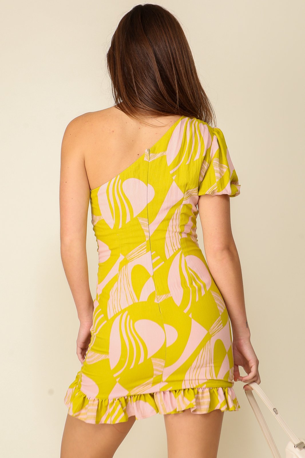 Becca Dress showcasing the chic one-shoulder design, vibrant colors, and playful ruffle hem from Raggdoll Boutique.