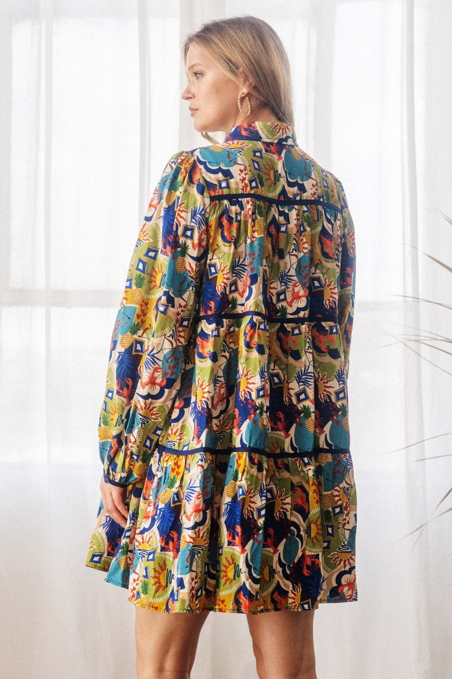 Back view of Poppy Baby Doll Shirt Dress showcasing vibrant print, ideal for coastal boutique clothing and tropical vacation dresses.