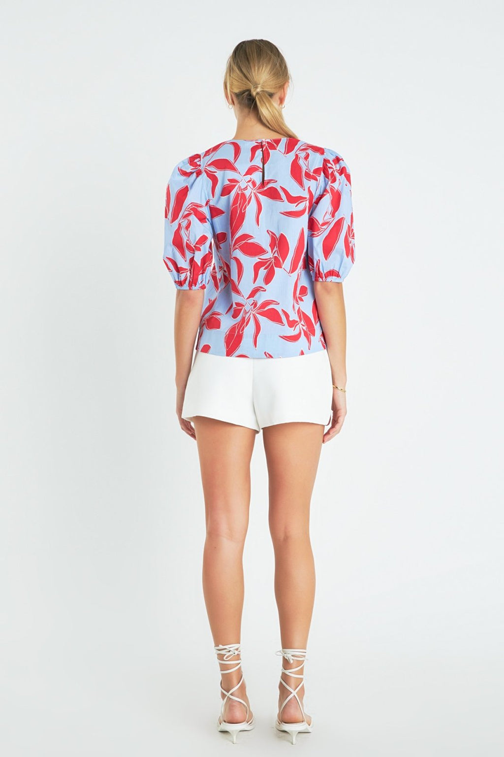 Back view of Blue, Red Puff Sleeve top featuring floral design, perfect for summer outfits Texas at Raggdoll Boutique.