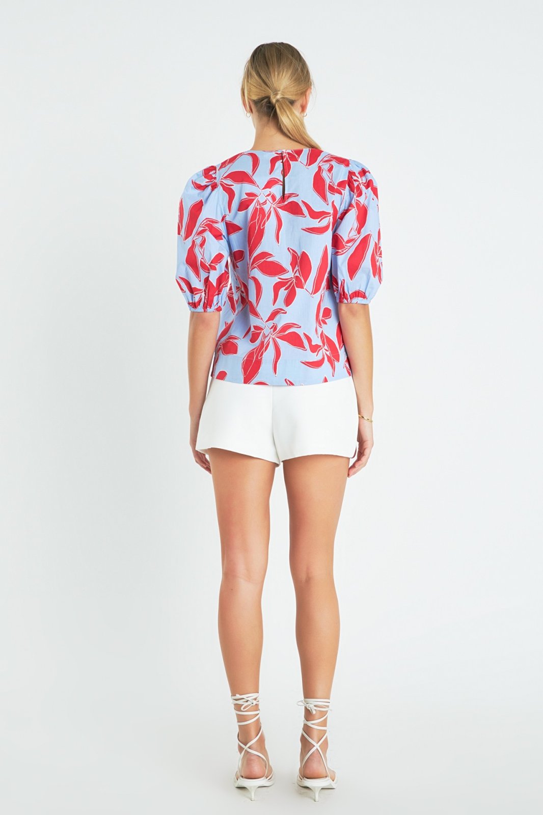Back view of Blue, Red Puff Sleeve top featuring floral design, perfect for summer outfits Texas at Raggdoll Boutique.