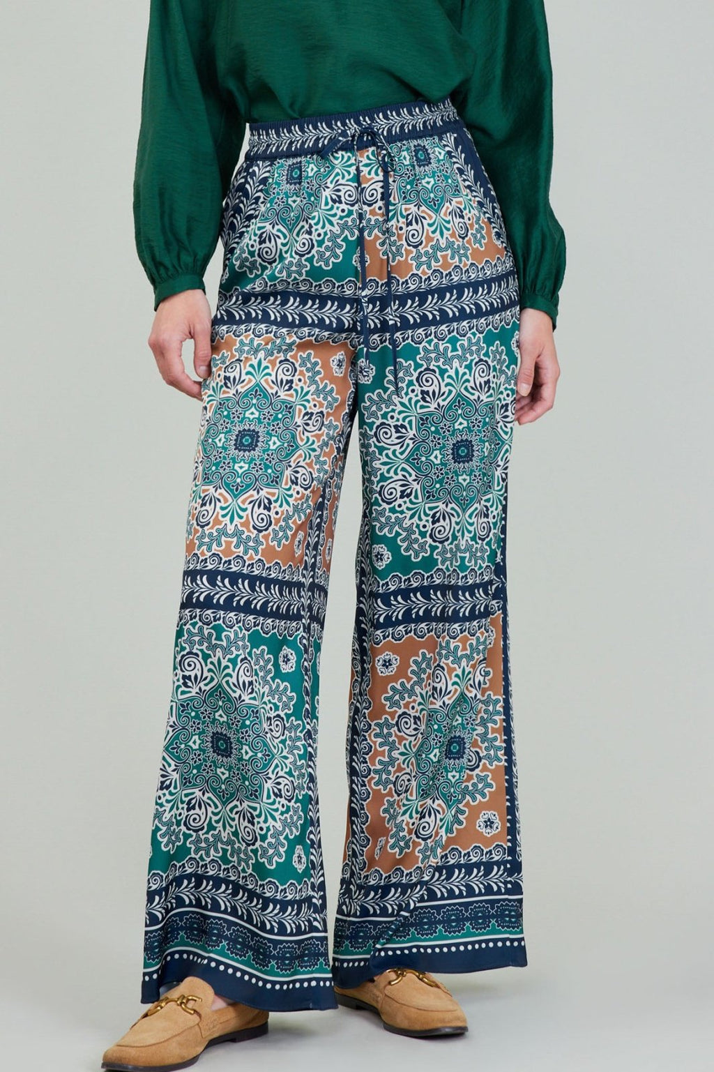 Stylish jewel-tone pants featuring a vibrant floral print, perfect for curated women's fashion at our Port Aransas boutique.
