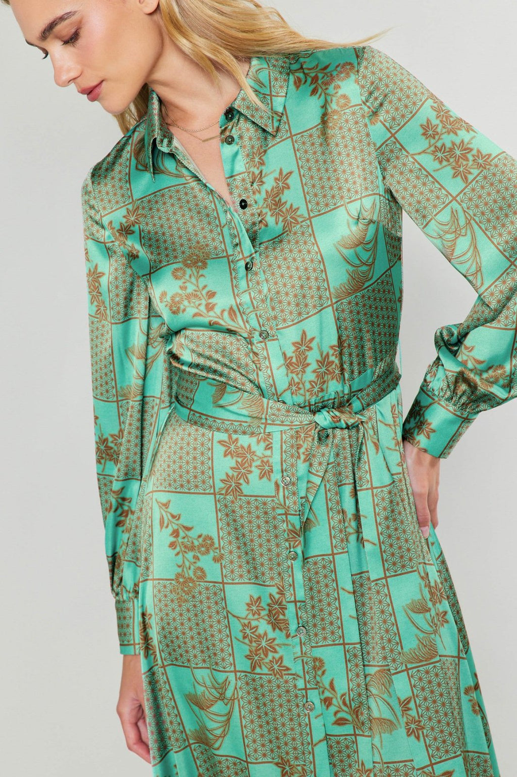 Jules Dress from a coastal boutique, featuring a vibrant green pattern, perfect for tropical vacations and curvy fashion.