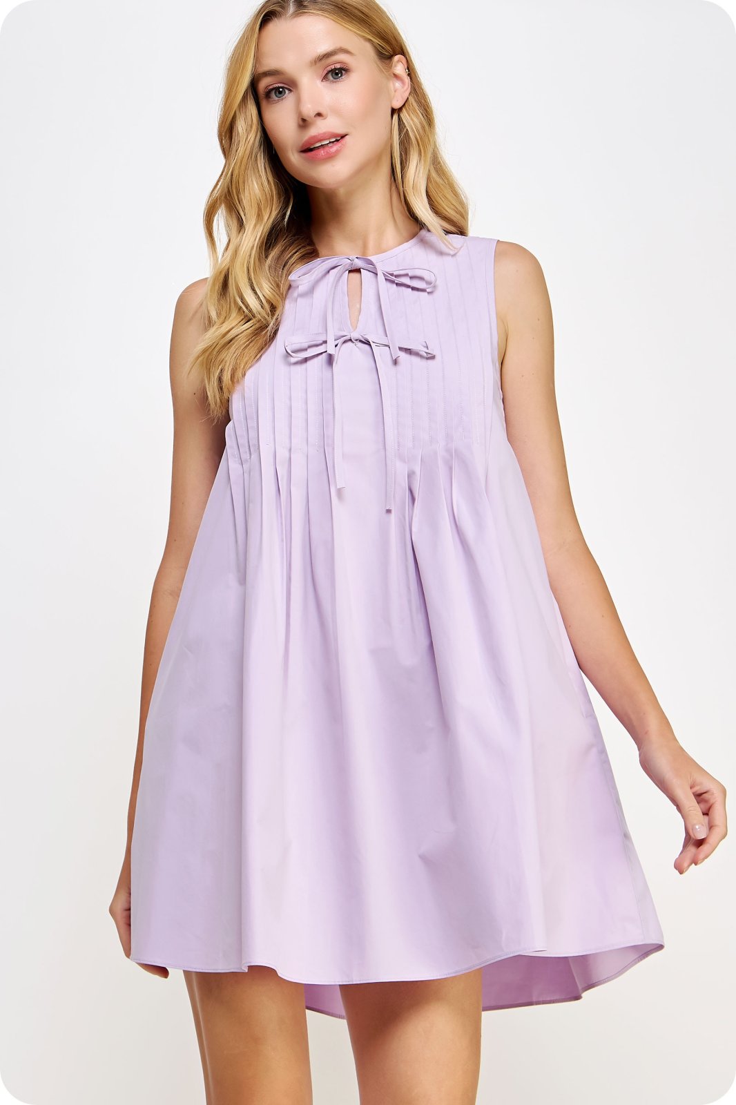 Lilla Dress from Raggdoll Boutique, a pintuck tie detail poplin mini dress perfect for vacation wardrobe.