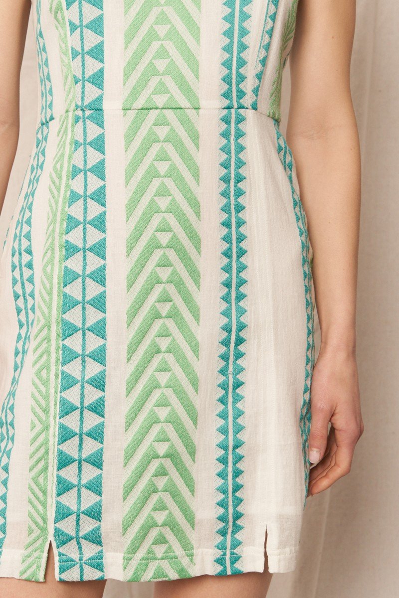 Mindy Dress featuring a vibrant green and blue geometric pattern, ideal for summer beach outings from a Port Aransas boutique.