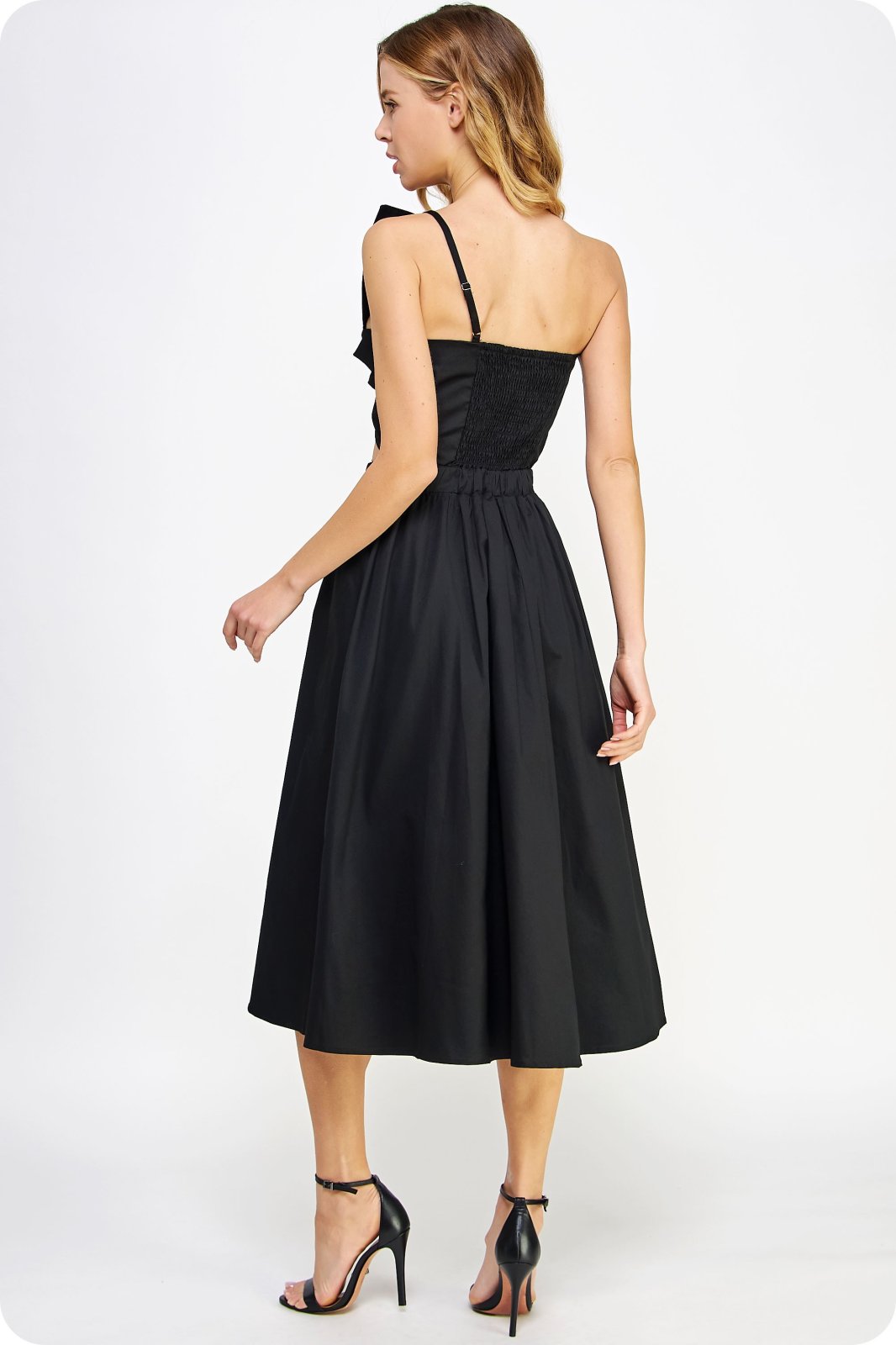 Sonya Dress back view in black, showcasing one shoulder design and pleated bow detail, from Raggdoll Boutique.
