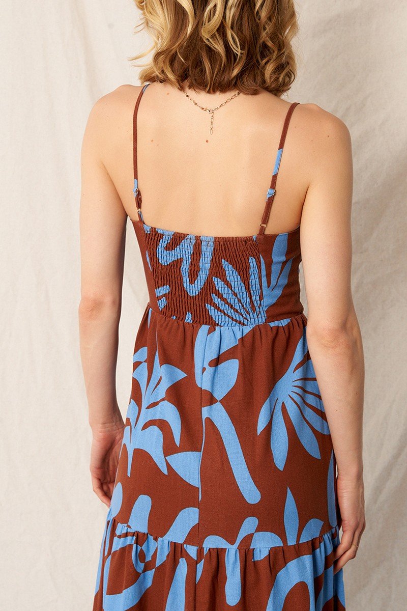 Woman wearing ABSTRACT PRINT MAXI BROWN/BLUE dress featuring tropical pattern, perfect for summer outfits Texas.