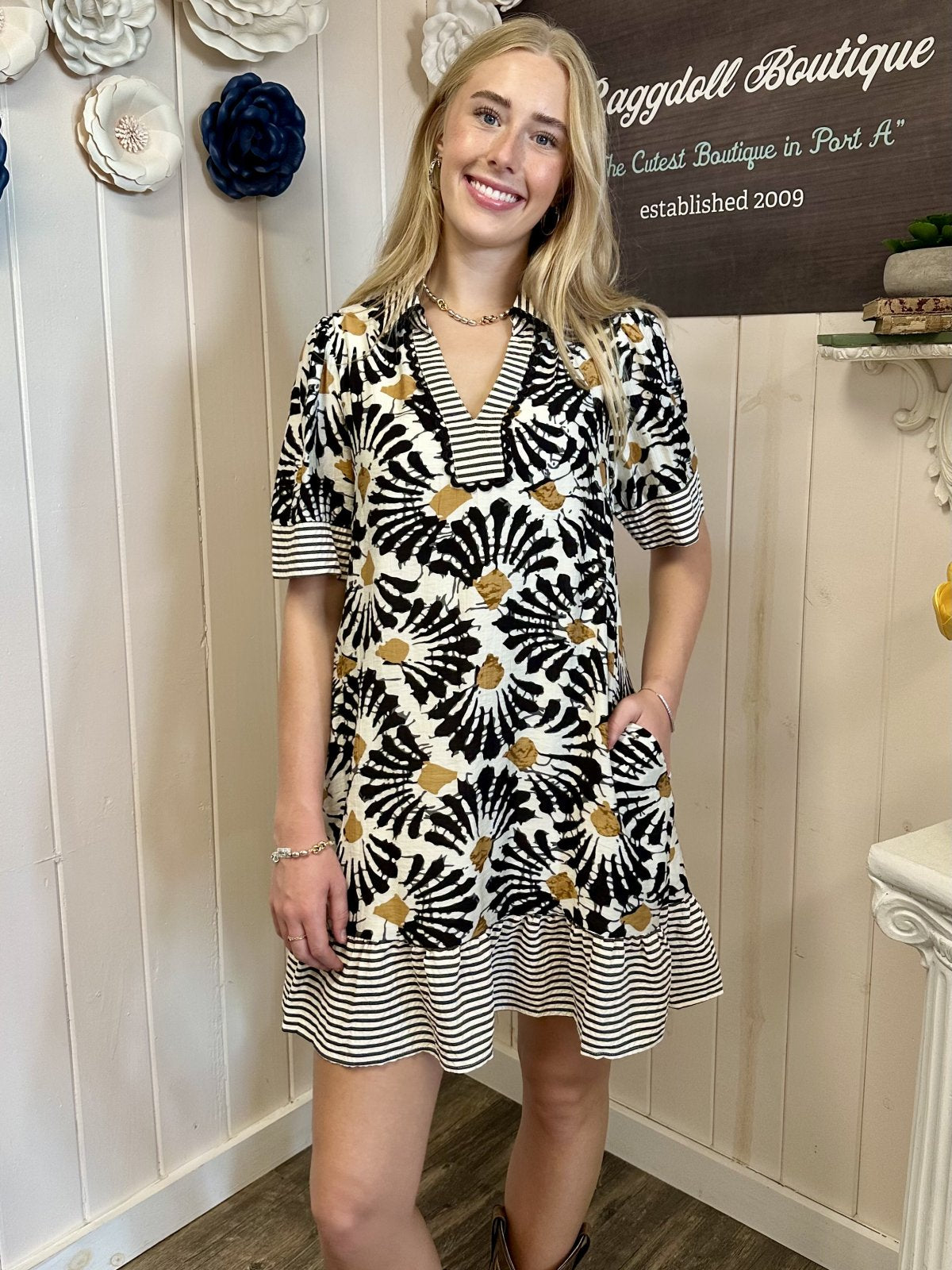 Eden Dress from Raggdoll Boutique, showcasing a half sleeve collared V-neck mini dress with floral print.