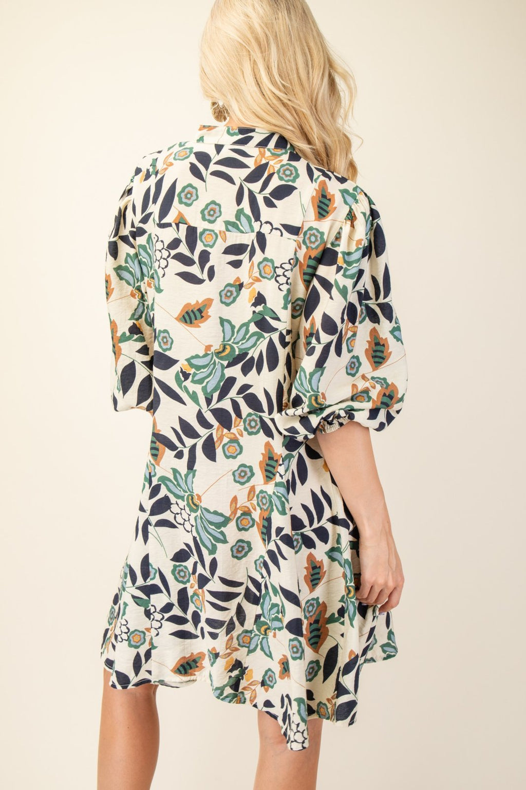 Back view of Lisa Dress showcasing floral pattern, perfect for coastal boutique clothing and tropical vacation dresses.