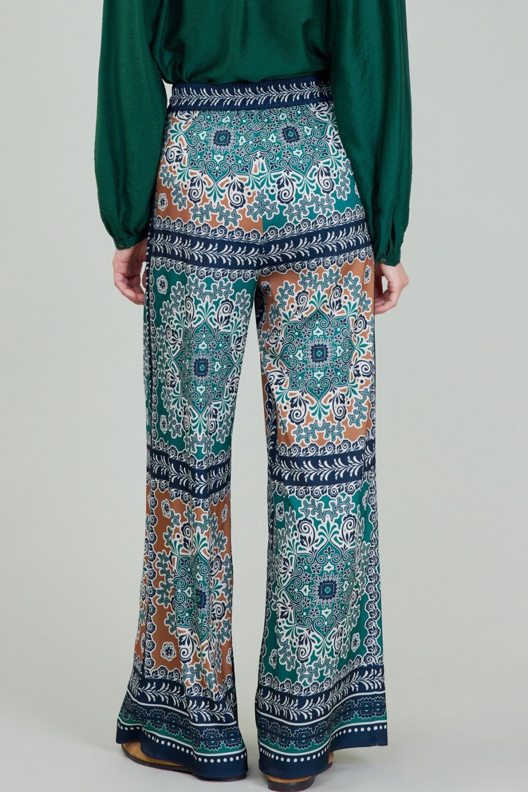 Stylish jewel-tone pants featuring intricate patterns, perfect for curvy plus size fashion at a coastal boutique.