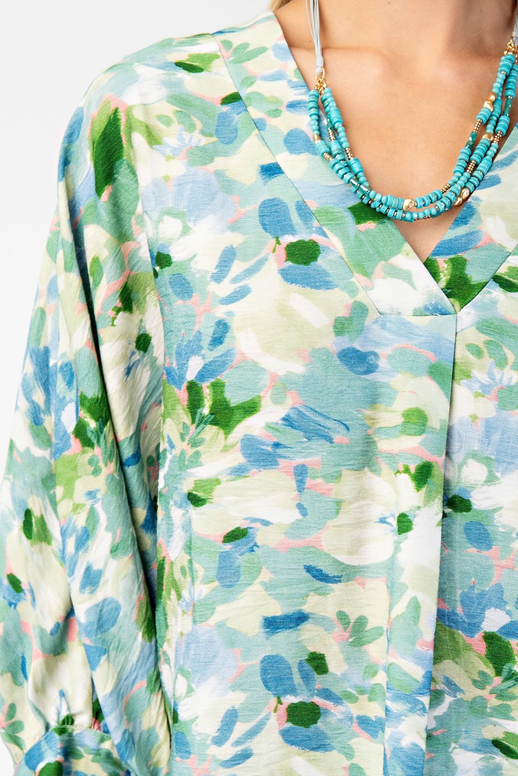 Stylish teal, pink, and green top from a coastal boutique, ideal for tropical vacations and curvy plus size fashion.