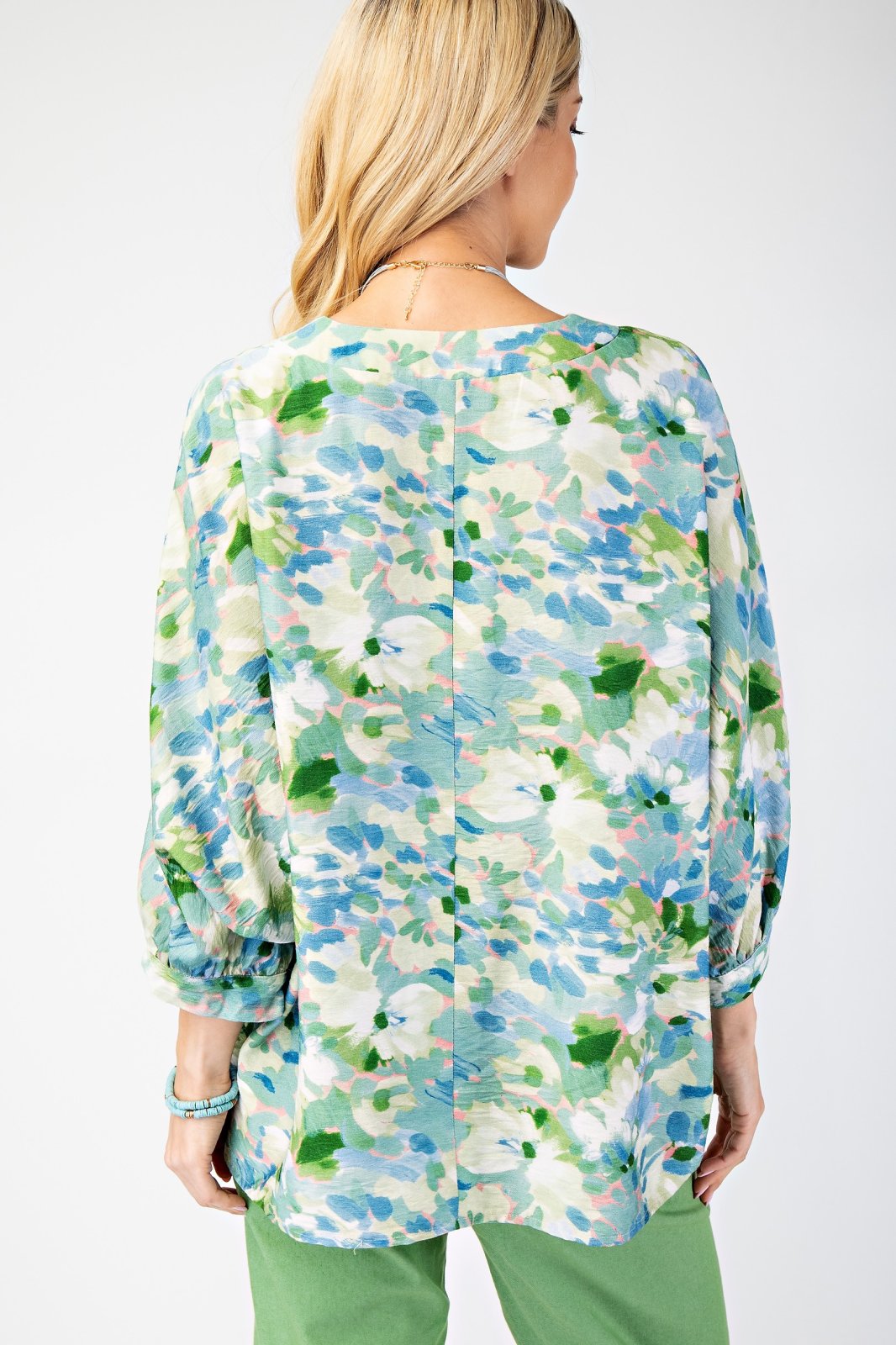 Back view of a stylish teal, pink, and green women's top perfect for coastal boutique clothing and tropical vacation dresses.