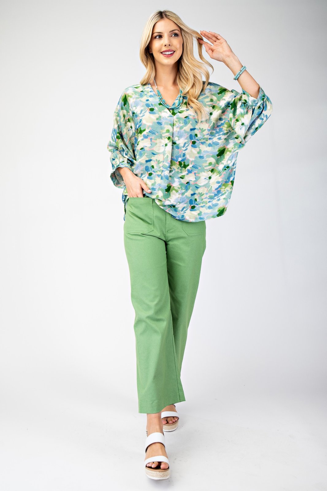 Stylish teal, pink, and green top paired with green pants, perfect for coastal boutique clothing and tropical vacation dresses.