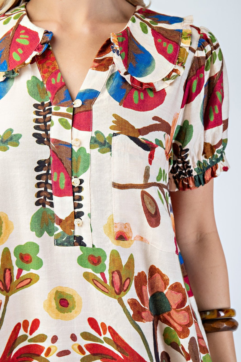 Colorful Katie Dress featuring floral patterns, perfect for coastal boutique clothing and tropical vacations.