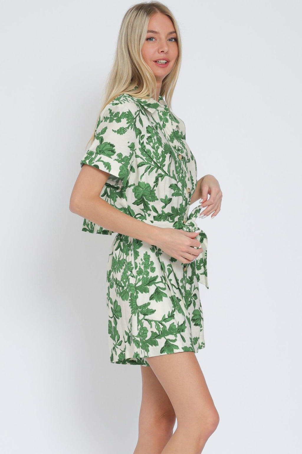 Ivory and green short sleeve romper from a coastal boutique, perfect for sunny days and laid-back weekends.