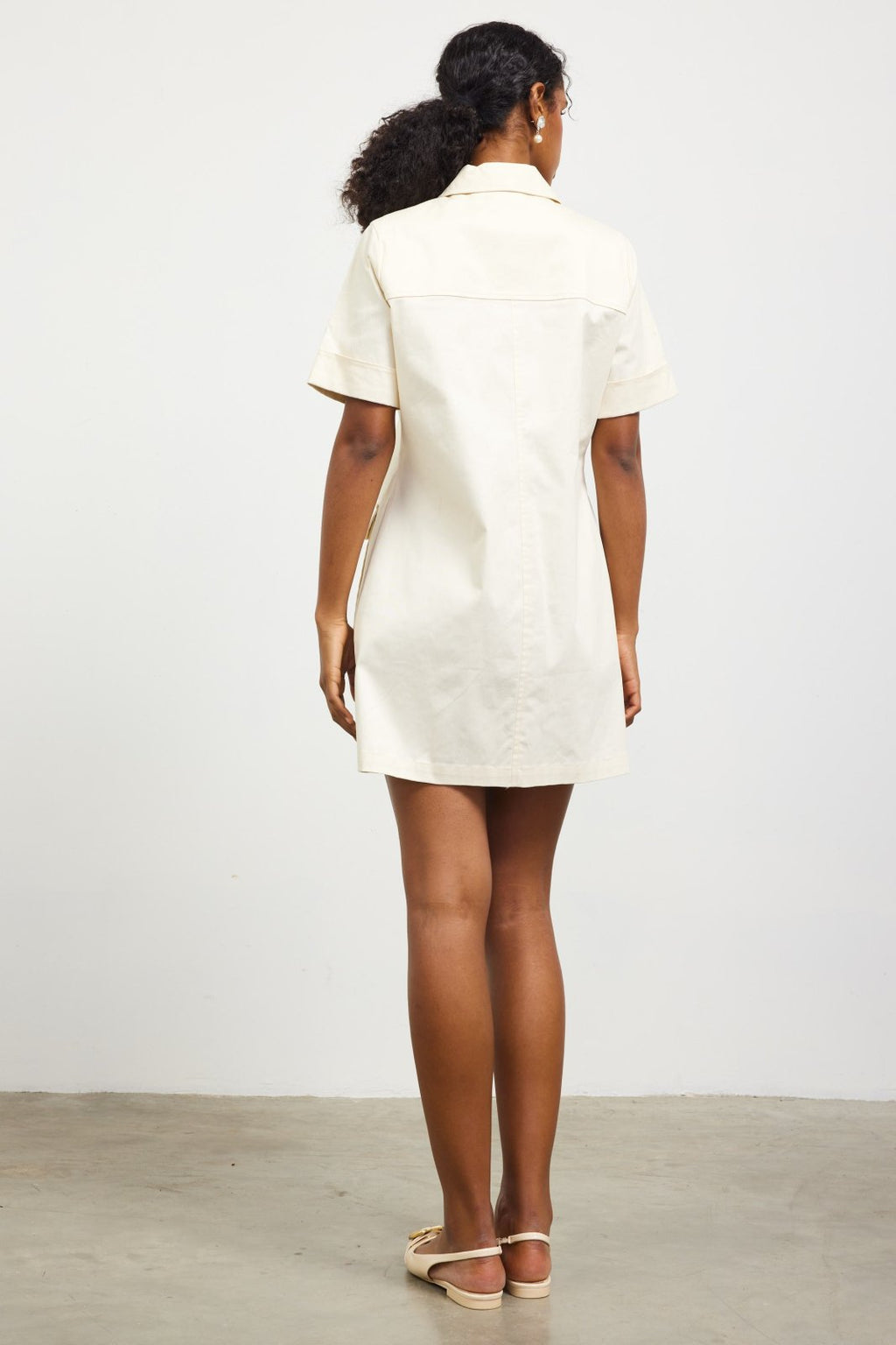 Back view of the Scottie Dress, a versatile beige dress ideal for beach outings, casual events, or lunch dates.