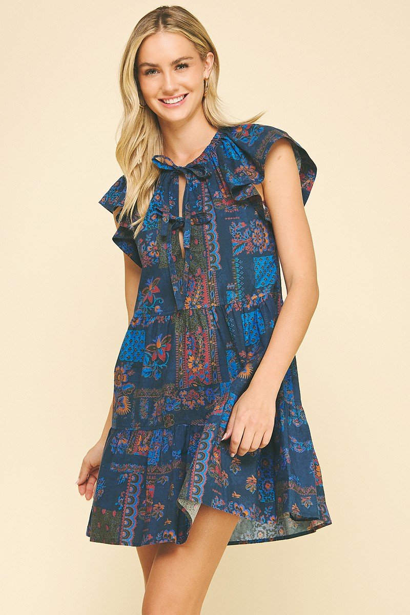 Elegant Carlie Dress in navy with floral patterns, perfect for coastal boutique clothing and tropical vacations.