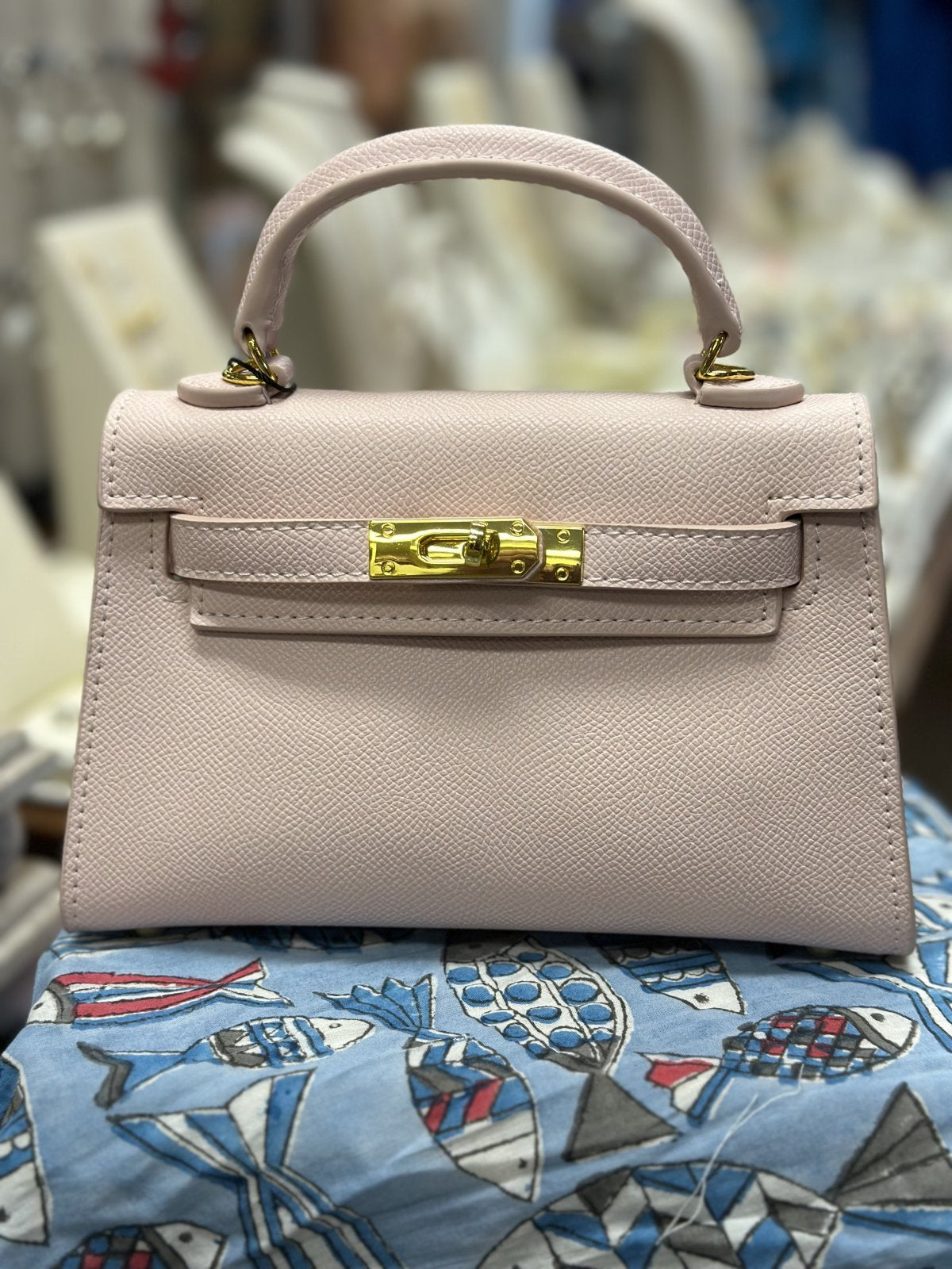 Stylish pink handbag with gold-tone hardware, perfect for curvy plus size fashion and elevated coastal boutique clothing.