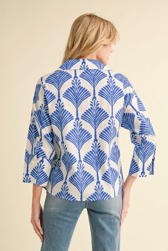 Playful royal blue print top with wide collar and pearl buttons, ideal for coastal boutique clothing or beach outings.