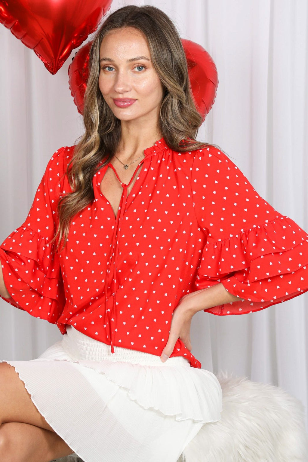 Stylish red polka dot hearts top from a coastal boutique, perfect for beach dresses and tropical vacations.