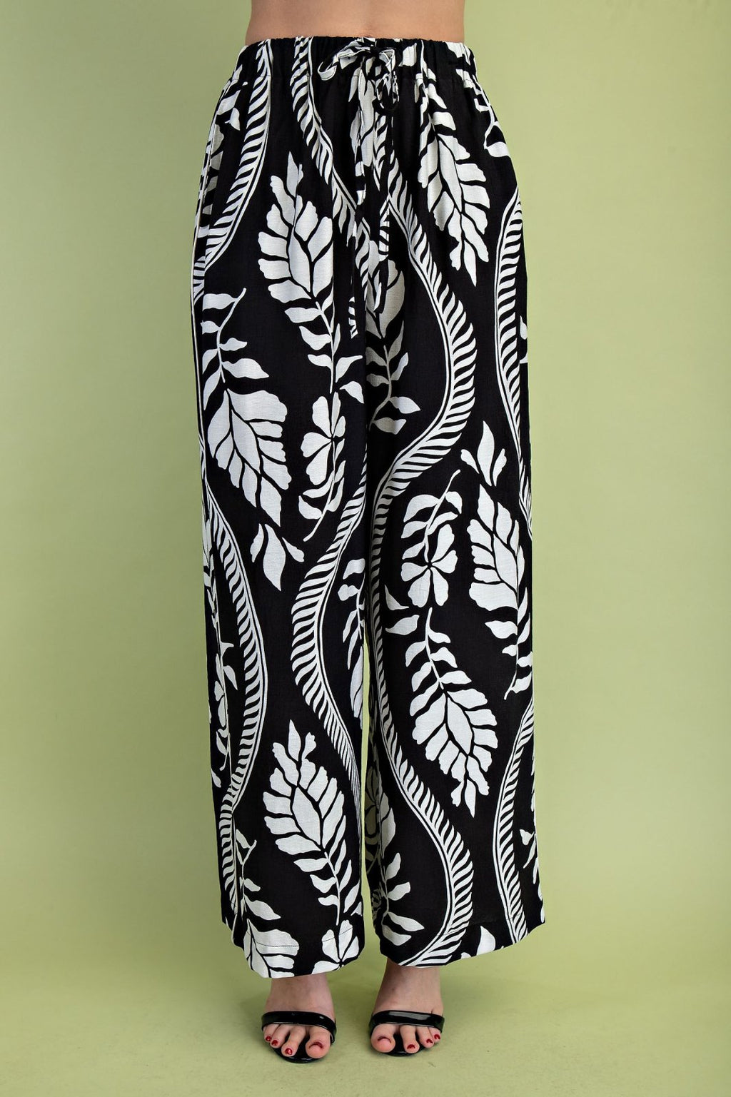 Stylish black leaf pattern drawstring pants from a coastal boutique, perfect for beach outings and curvy plus size fashion.